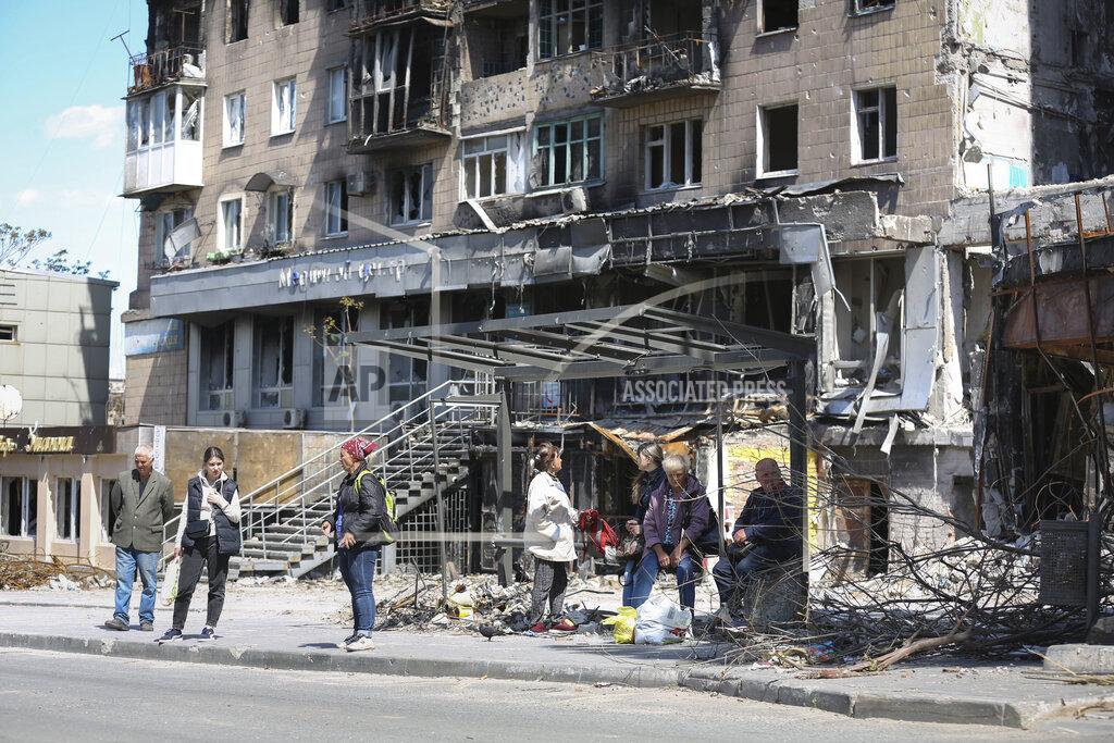Alexei Alexandrov Local residents stand at a bus stop in Mariupol, in territory under the government of the Donetsk People's Republic, eastern Ukraine, Tuesday, May 17, 2022. (AP Photo/Alexei Alexandrov)