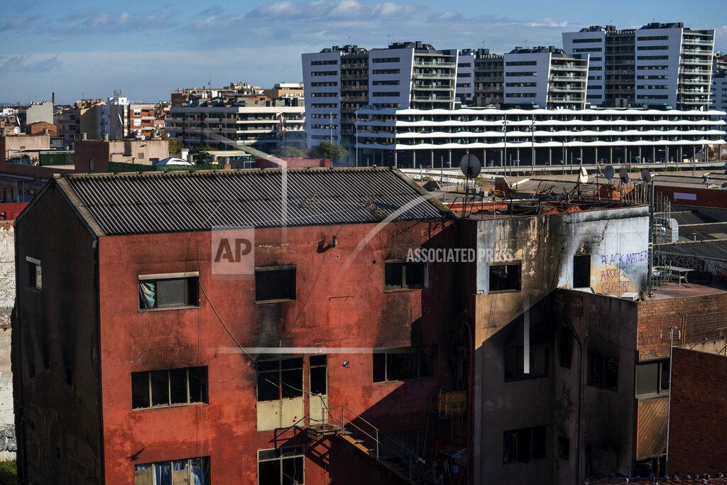 Emilio Morenatti View of a building after a fire in Badalona, Barcelona, Spain, Thursday, Dec. 10, 2020. Firefighters in northeastern Spain found two bodies in an abandoned industrial complex occupied by migrants and other squatters that caught fire and partially collapsed, while ongoing emergency work assisted by drones on Thursday tried to assess if more people were trapped inside. (AP Photo/Emilio Morenatti)