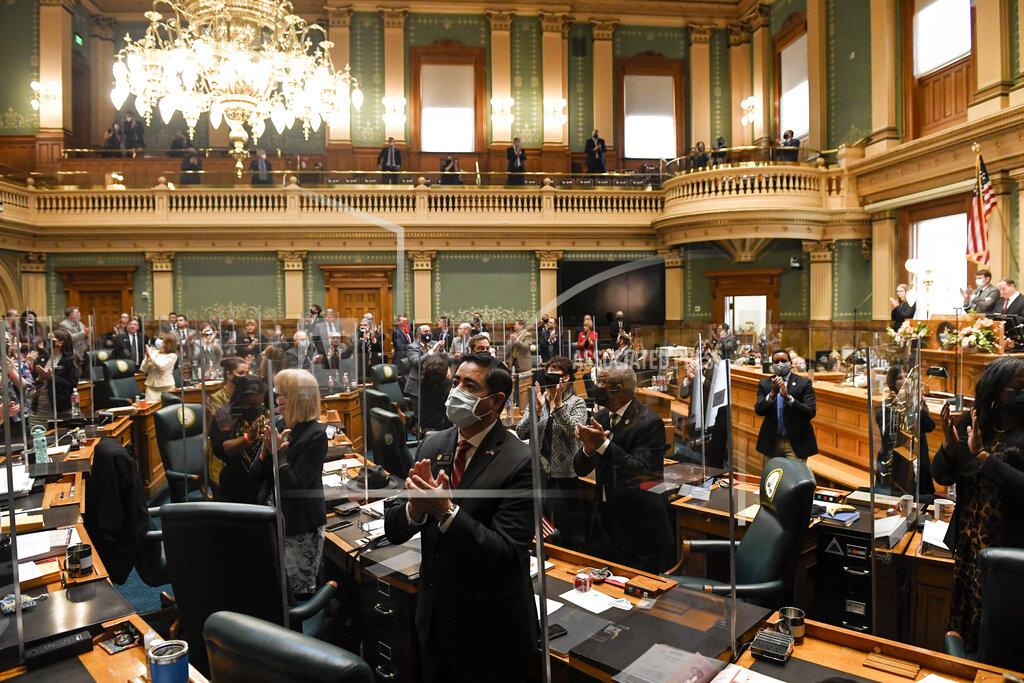 Aaron Ontiveroz Rep. Donald Valdez and fellow members applaud during state of the state at the Colorado State Capitol Building in Denver on Wednesday, Feb. 17, 2021. (AAron Ontiveroz/The Denver Post via AP, Pool)