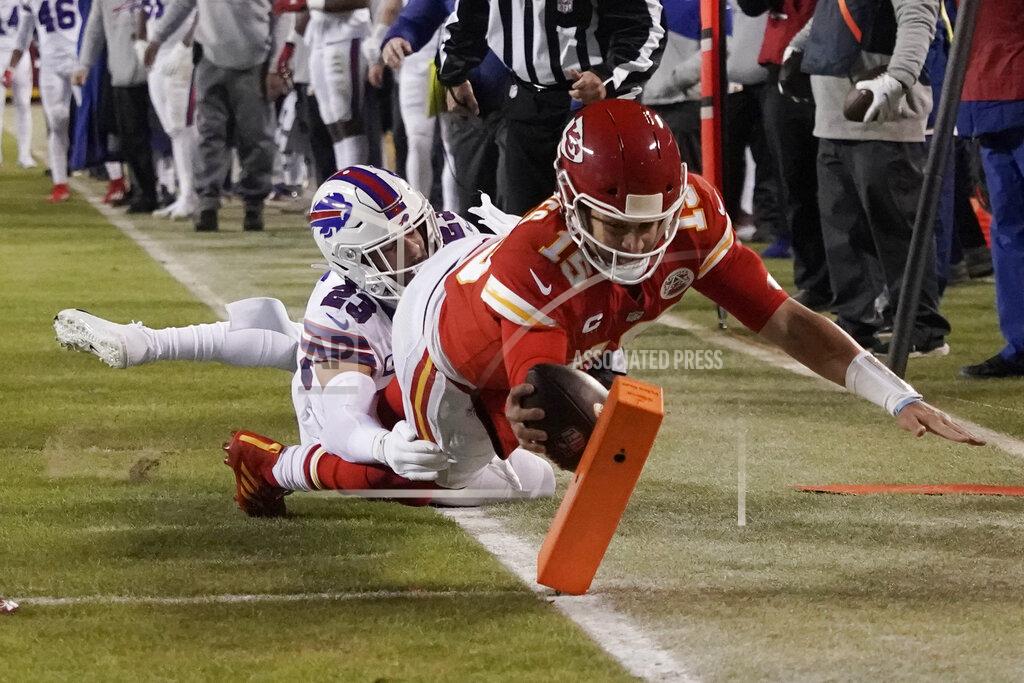Charlie Riedel Kansas City Chiefs quarterback Patrick Mahomes (15) scores on an 8-yard touchdown run ahead of Buffalo Bills safety Micah Hyde (23) during the first half of an NFL divisional round playoff football game, Sunday, Jan. 23, 2022, in Kansas City, Mo. (AP Photo/Charlie Riedel)