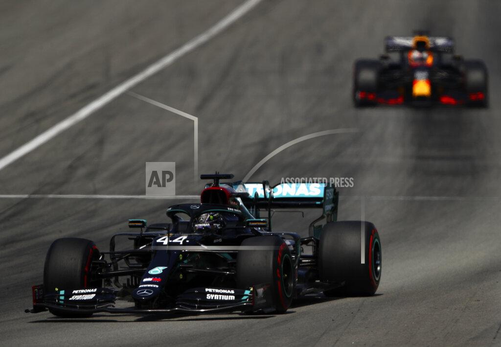 Bryn Lennon Mercedes driver Lewis Hamilton of Britain steers his car followed by Red Bull driver Max Verstappen of the Netherlands during the Formula One Grand Prix at the Barcelona Catalunya racetrack in Montmelo, Spain, Sunday, Aug. 16, 2020. (Bryn Lennon, Pool via AP)