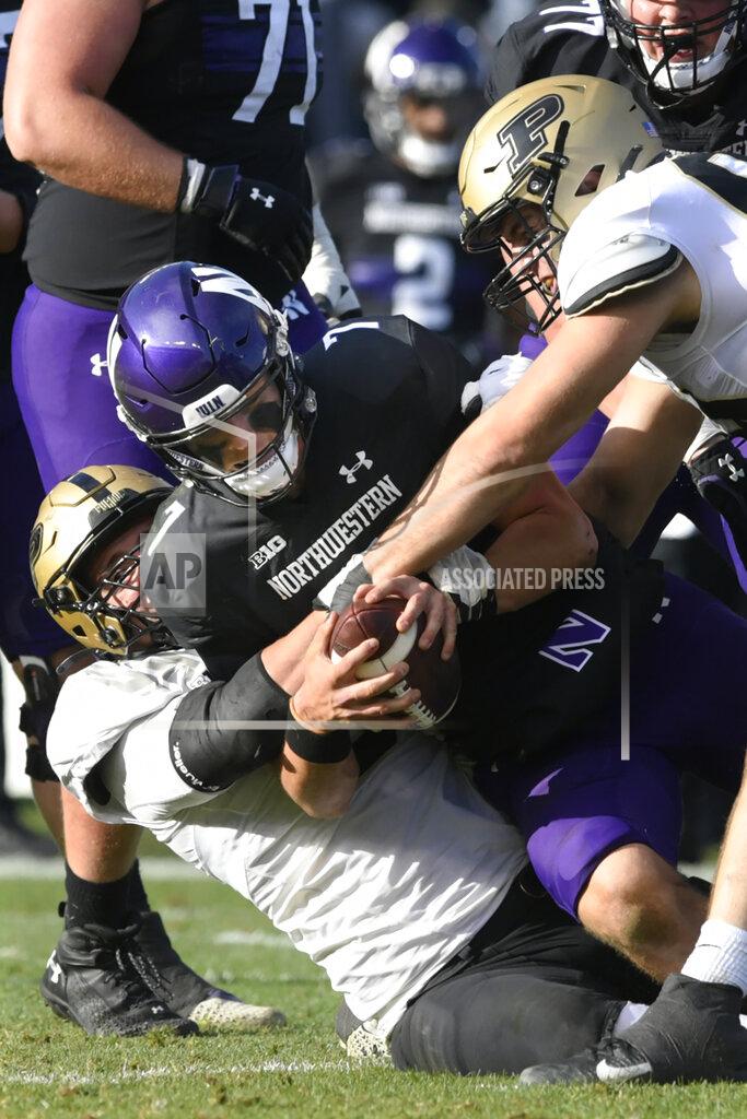 Paul Beaty Purdue's Jack Sullivan (99) and George Karlafits (5) sack Northwestern quarterback Ryan Hilinski (12) during the second half of an NCAA college football game, Saturday, Nov. 20, 2021 at Wrigley Field in Chicago. Purdue won 32-14. (AP Photo/Paul Beaty)