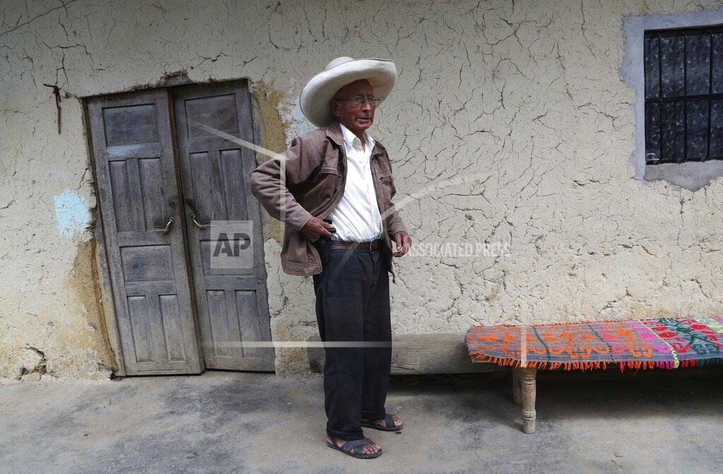 Martin Mejia Ireño Castillo, the father of Free Peru party presidential candidate Pedro Castillo, stands inside his home in Puna, Peru, Friday, April 16, 2021. Ireño's rural teacher son, who has proposed rewriting Peru's constitution and deporting all immigrants living in the country illegally who commit crimes, will face rival candidate Keiko Fujimori in the June 6 presidential run-off election. (AP Photo/Martin Mejia)