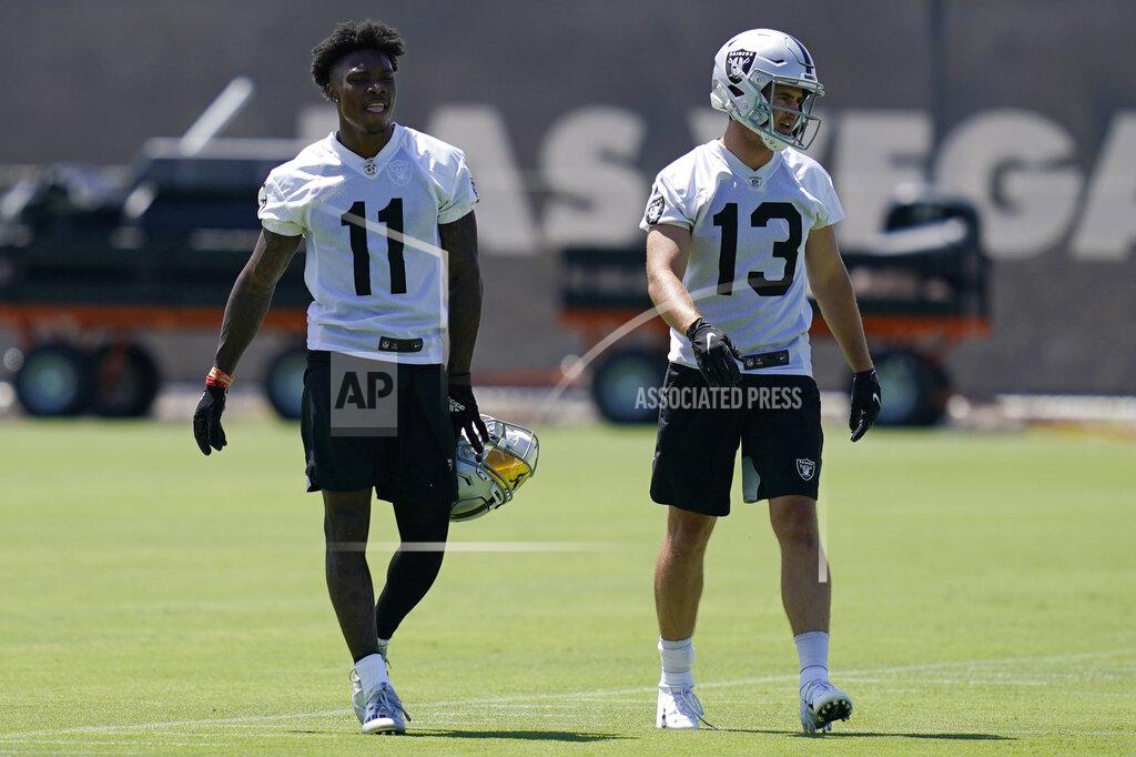 Las Vegas Raiders wide receiver Henry Ruggs III (11) and wide receiver Hunter Renfrow (13) walk down the field during NFL football practice Wednesday, June 2, 2021, in Henderson, Nev. (AP Photo/John Locher)