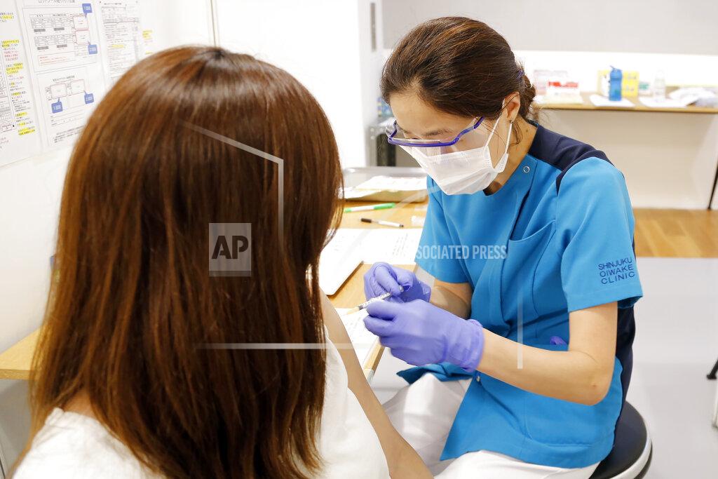 Yuri Kageyama A medical worker gets Moderna's COVID-19 vaccine at an inoculation site set up by Japanese technology company SoftBank Group Corp. at a WeWork office Tuesday, June 15, 2021, in Tokyo. Japanese companies have joined the effort to speed up the country’s lagging coronavirus vaccine rollout before the Tokyo Olympics begin next month. (AP Photo/Yuri Kageyama)