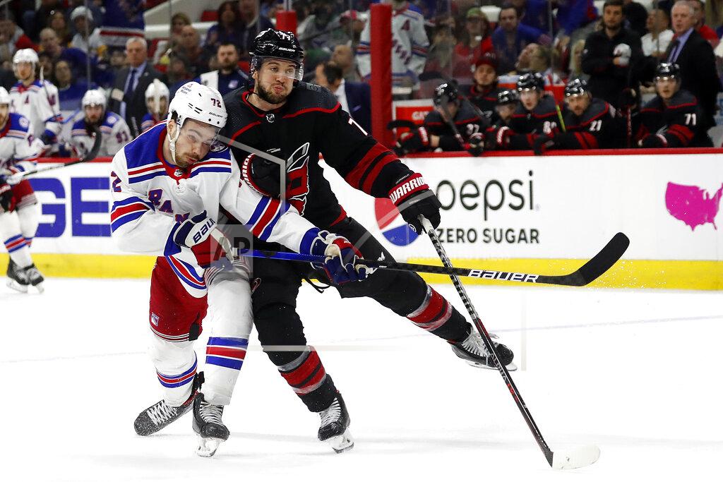 Karl B Deblaker Carolina Hurricanes' Tony DeAngelo (77) collides with New York Rangers' Filip Chytil (72) during the third period of Game 2 of an NHL hockey Stanley Cup second-round playoff series in Raleigh, N.C., Friday, May 20, 2022. (AP Photo/Karl B DeBlaker)
