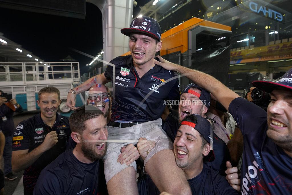 Hassan Ammar Red Bull driver Max Verstappen of the Netherlands celebrates with his team after he became the world champion after winning the Formula One Abu Dhabi Grand Prix in Abu Dhabi, United Arab Emirates, Sunday, Dec. 12, 2021, (AP Photo/Hassan Ammar)