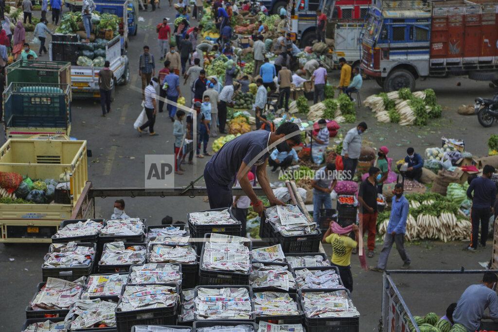 Channi Anand FILE - In this May 4, 2021, file photo, a laborer works on a truck at a vegetable market in Jammu, India. The World Health Organization said Monday, May 10, that a worrisome variant was first detected in India may spread more easily. Scientists are still trying to figure out if it resulted in the terrifying surge of infections in the nation, and looking to see if this could this happen elsewhere. (AP Photo/Channi Anand, File)