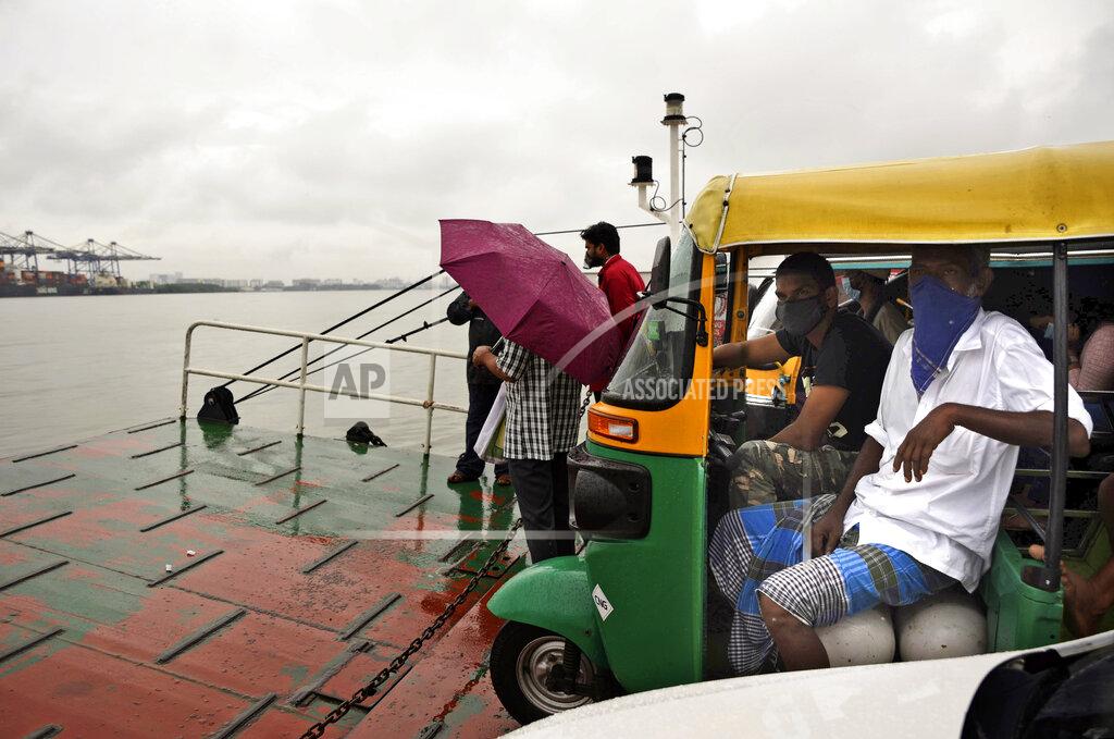 R S Iyer Commuters wearing masks as a precaution against the coronavirus travel in a ferry during rain in Kochi, Kerala state, India, Monday, June 22 2020. India is the fourth hardest-hit country by the COVID-19 pandemic in the world after the U.S., Russia and Brazil. (AP Photo/R S Iyer)