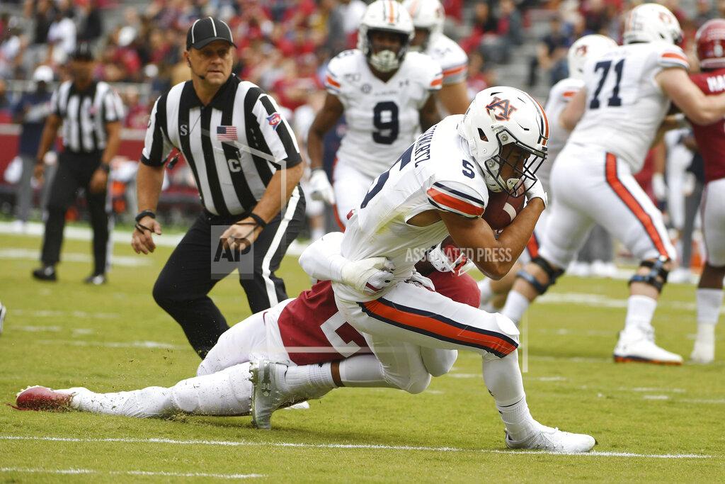 Michael Woods Auburn receiver Anthony Schwartz is tackled just short of the goal line by Arkansas defender Kamren Curl during the first half of an NCAA college football game, Saturday, Oct. 19, 2019 in Fayetteville, Ark. (AP Photo/Michael Woods)