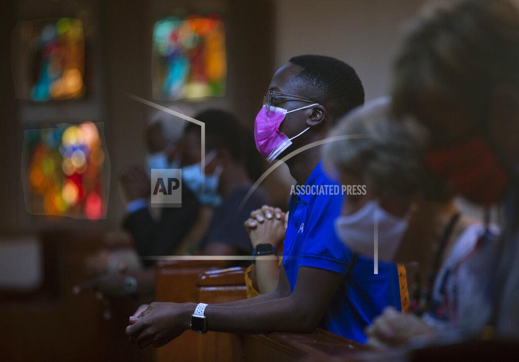 Denis Farrell Congregants wear face masks to protect against coronavirus as they attend an Easter Sunday Mass at the Roman Catholic Church in Rosebank, Johannesburg, Sunday March 4, 2021. (AP Photo/Denis Farrell)