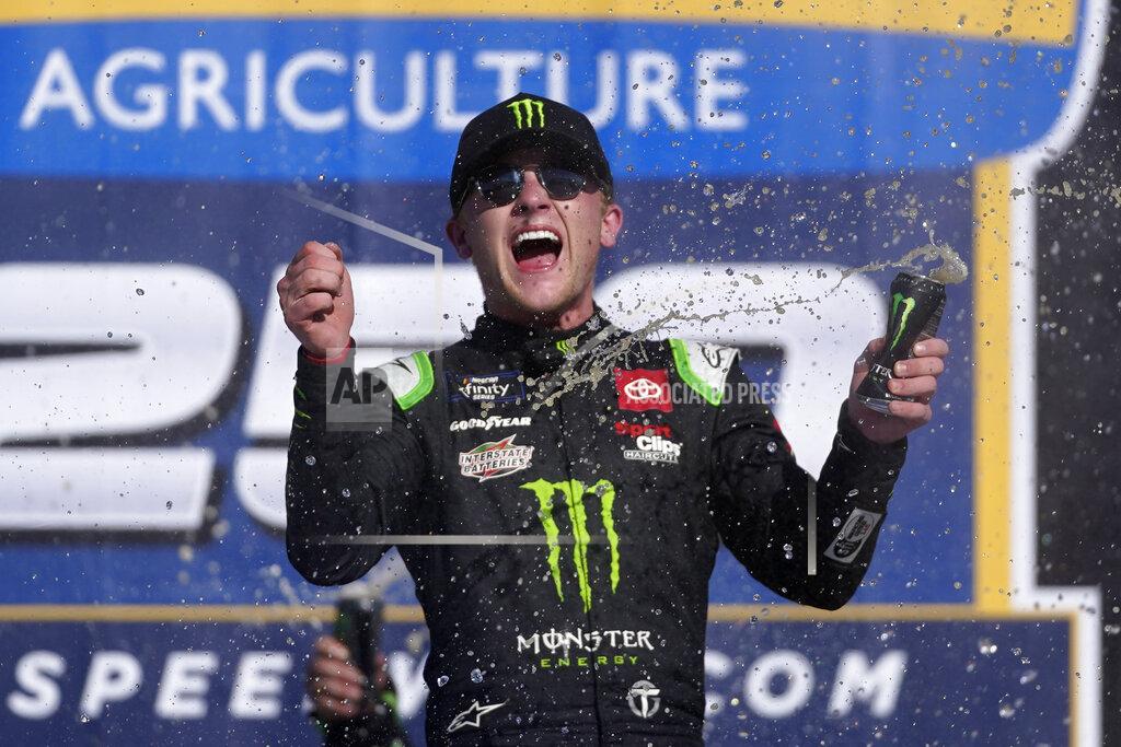 Paul Sancya Ty Gibbs celebrates winning the New Holland 250 NASCAR Xfinity Series auto race at the Michigan International Speedway in Brooklyn, Mich., Saturday, Aug. 6, 2022. (AP Photo/Paul Sancya)