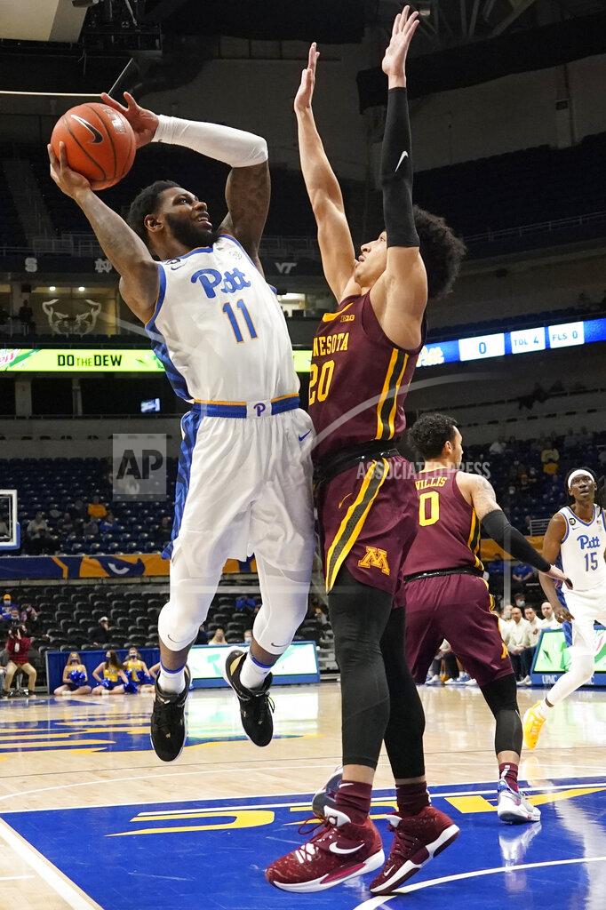 Keith Srakocic Pittsburgh's Jamarius Burton (11) shoots as Minnesota's E.J. Stephens (20) defends during the first half of an NCAA college basketball game Tuesday, Nov. 30, 2021, in Pittsburgh. (AP Photo/Keith Srakocic)