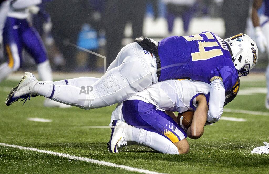Daniel Lin James Madison linebacker Kelvin Azanama (54) tackles Northern Iowa quarterback Will McElvain (13) during the first half of a quarterfinal game in the NCAA college Football Championship Subdivision playoffs in Harrisonburg, Va., Friday, Dec. 13, 2019. (Daniel Lin/Daily News-Record via AP)