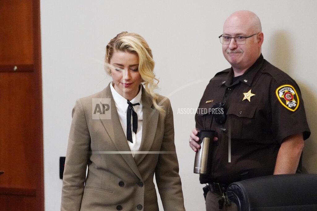 Steve Helber Actor Amber Heard arrives into the courtroom after a break at the Fairfax County Circuit Courthouse in Fairfax, Va., Monday, May 23, 2022. Actor Johnny Depp sued his ex-wife Amber Heard for libel in Fairfax County Circuit Court after she wrote an op-ed piece in The Washington Post in 2018 referring to herself as a "public figure representing domestic abuse." (AP Photo/Steve Helber, Pool)