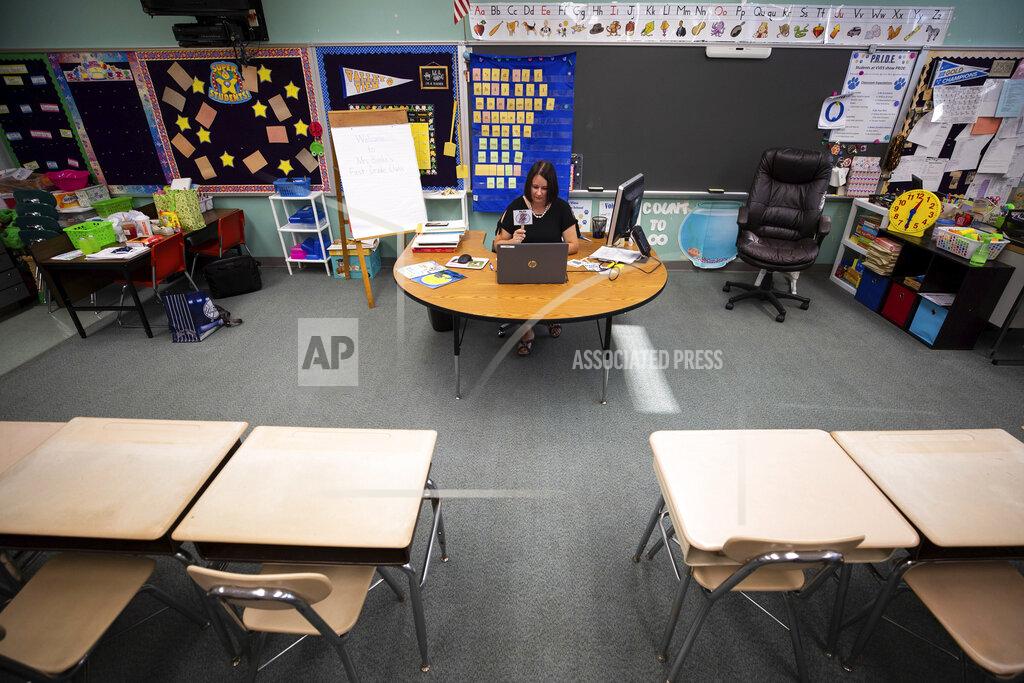 Christopher Dolan FILE — In this Aug. 27, 2020 file photo, Valley View Elementary School first grade teacher Janelle Benke teaches a virtual lesson in her empty classroom on the first day of classes for Valley View in Blakely, Pa. (Christopher Dolan/The Times-Tribune via AP)