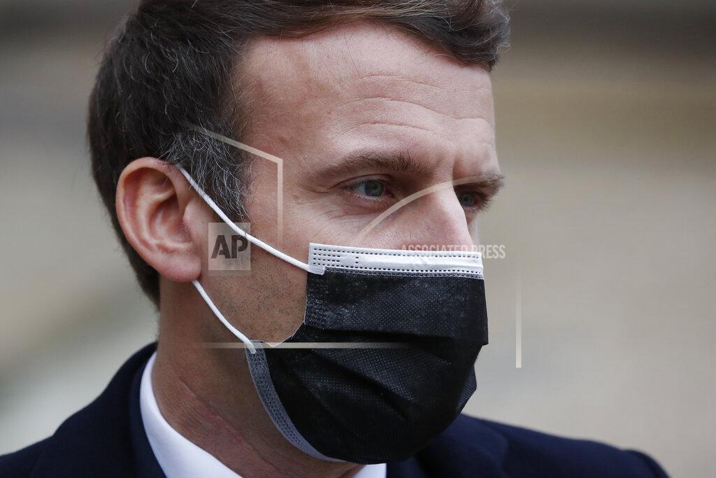 Francois Mori French President Emmanuel Macron reacts as he meets Portuguese Prime Minister Antonio Costa, Wednesday, Dec. 16, 2020 in Paris. French President Emmanuel Macron has tested positive for COVID-19, the presidential Elysee Palace announced on Thursday. (AP Photo/Francois Mori)