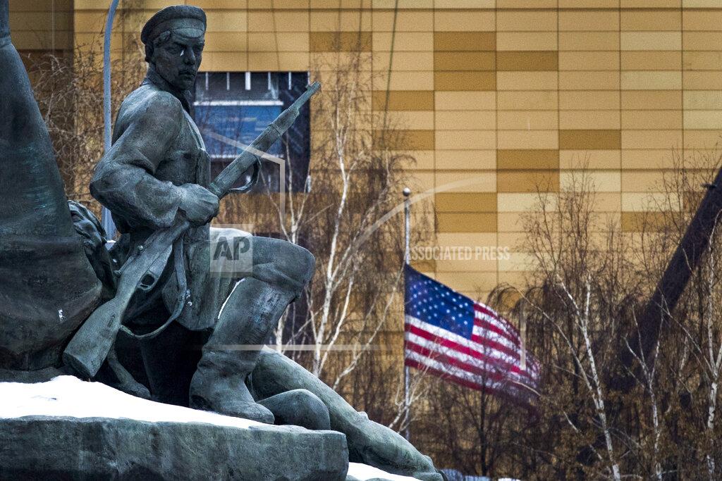 Alexander Zemlianichenko FILE - In this file photo taken on Friday, Dec. 30, 2016, The U.S. Embassy with its national flag, seen behind a monument to the Workers of 1905 Revolution in Moscow, Russia. Russian Foreign Minister Sergey Lavrov says Moscow will order 10 U.S. diplomats to leave Russia in a retaliatory response to the U.S. sanctions. Lavrov also said Moscow will add eight U.S. officials to its sanctions list and move to restrict and stop the activities of U.S. nongovernmental organizations from interfering in Russia's politics. (AP Photo/Alexander Zemlianichenko, File)