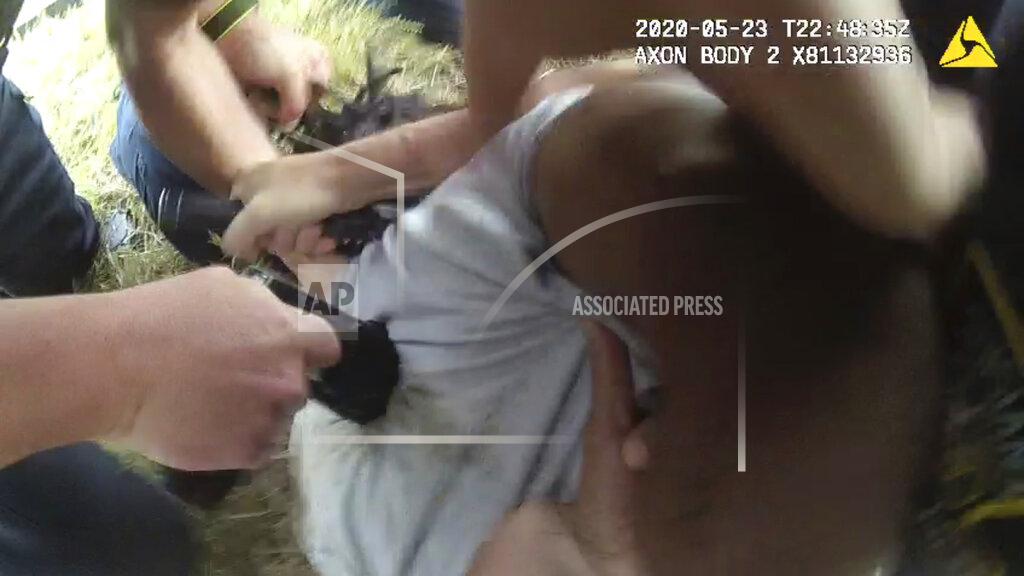 Larry Shappley In this Saturday, May 23, 2020 image from Louisiana State Police body camera video, an unidentified law enforcement officer applies an electric weapon to the back of Black motorist Antonio Harris as other officers restrain him on the side of a road after a high speed chase in Franklin Parish, La. Troopers exchanged 14 text messages peppered with "lol" and "haha" responses in which they boasted about the beating. (Larry Shappley/Louisiana State Police via AP)