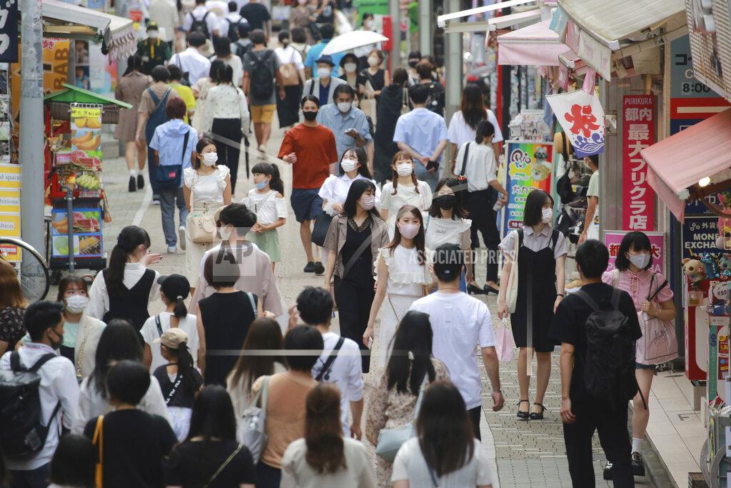 Koji Sasahara People wearing face masks to protect against the spread of the coronavirus walk through Takeshita street in Tokyo, Wednesday, July 28, 2021. Tokyo Gov. Yuriko Koike on Wednesday urged younger people to cooperate with measures to bring down the high number of infections and get vaccinated, saying their activities are key to slowing the surge during the Olympics. (AP Photo/Koji Sasahara)