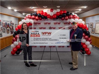 Sport Clips Haircuts presented a record-breaking $1.55 million check today to the Veterans of Foreign Wars of the United States (VFW) Foundation to provide scholarships for service members and veterans. Shown here, Amanda Palm (l) Sport Clips Haircuts communications manager and (r) VFW National Commander Fritz Mihelcic. (Photo: Business Wire)