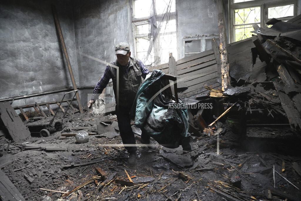Alexei Alexandrov A man takes out chairs in a house destroyed by shelling in Donetsk, in territory under the government of the Donetsk People's Republic, eastern Ukraine, Thursday, May 19, 2022. (AP Photo/Alexei Alexandrov)