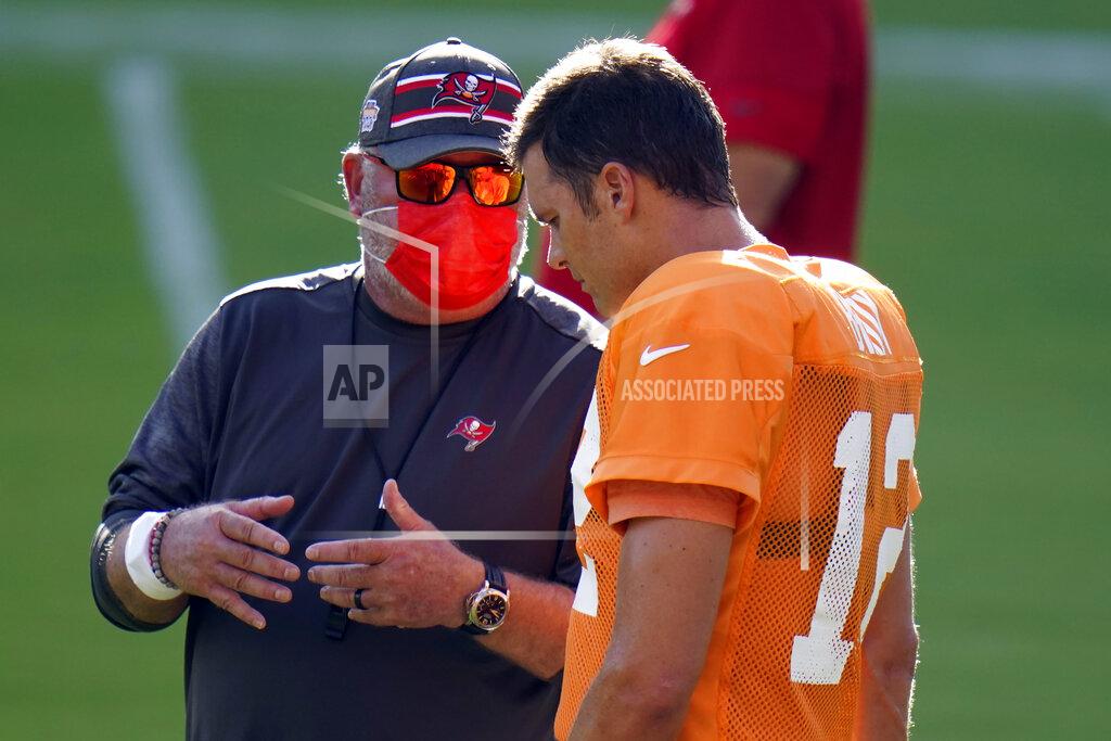 Tampa Bay Buccaneers head coach Bruce Arians talks to quarterback Tom Brady (12) during an NFL football training camp practice Friday, Aug. 28, 2020, in Tampa, Fla. (AP Photo/Chris O'Meara)