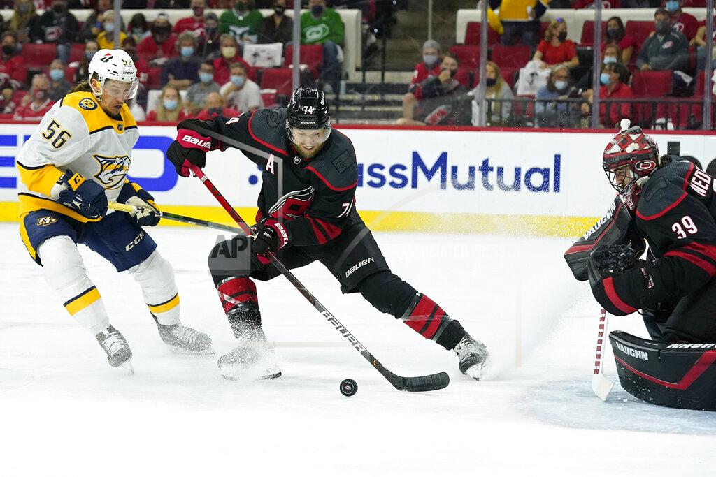 Gerry Broome Carolina Hurricanes defenseman Jaccob Slavin (74) and goaltender Alex Nedeljkovic (39) defend the goal against Nashville Predators left wing Erik Haula (56) during the first period in Game 5 of an NHL hockey Stanley Cup first-round playoff series in Raleigh, N.C., Tuesday, May 25, 2021. (AP Photo/Gerry Broome)