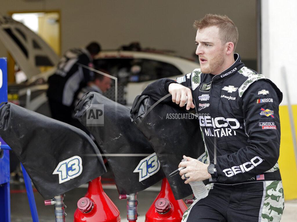 John Raoux Ty Dillon takes a break outside his garage after a NASCAR auto race practice at Daytona International Speedway, Thursday, July 4, 2019, in Daytona Beach, Fla. (AP Photo/John Raoux)