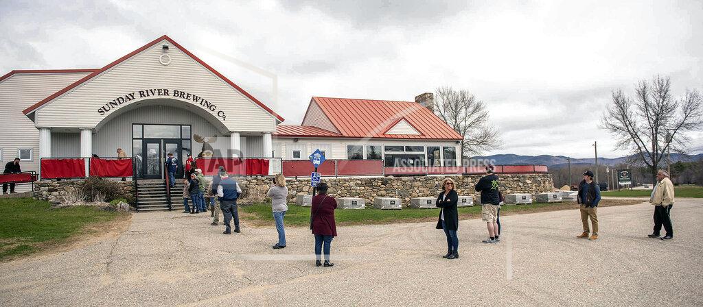 Andree Kehn Customers wait in a social-distance appropriate line before entering the Sunday River Brewing Company on Tuesday morning, May 5, 2020, in Bethel, Maine. (Andree Kehn/Sun Journal via AP)