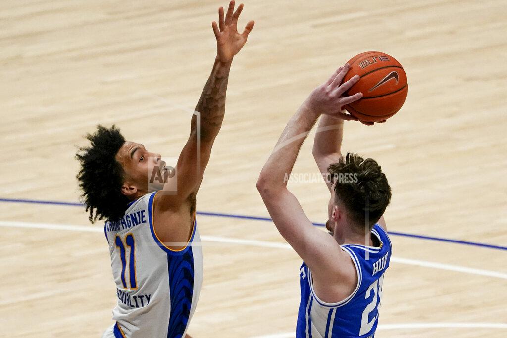 Keith Srakocic Pittsburgh's Justin Champagnie (11) defends as Duke's Matthew Hurt shoots during the second half of an NCAA college basketball game, Tuesday, Jan. 19, 2021, in Pittsburgh. Pittsburgh won 79-73. (AP Photo/Keith Srakocic)