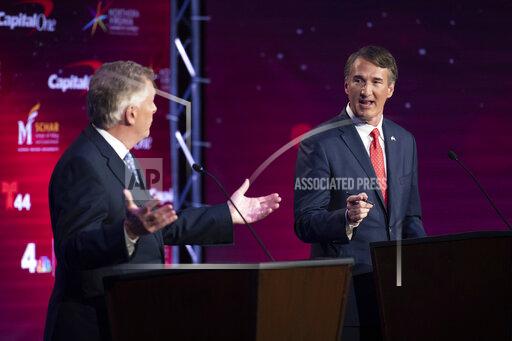 Virginia Democratic gubernatorial candidate and former Gov. Terry McAuliffe, left, and Republican challenger, Glenn Youngkin, participate in their debate at Northern Virginia Community College, in Alexandria, Va., Tuesday, Sept. 28, 2021. (AP Photo/Cliff Owen)