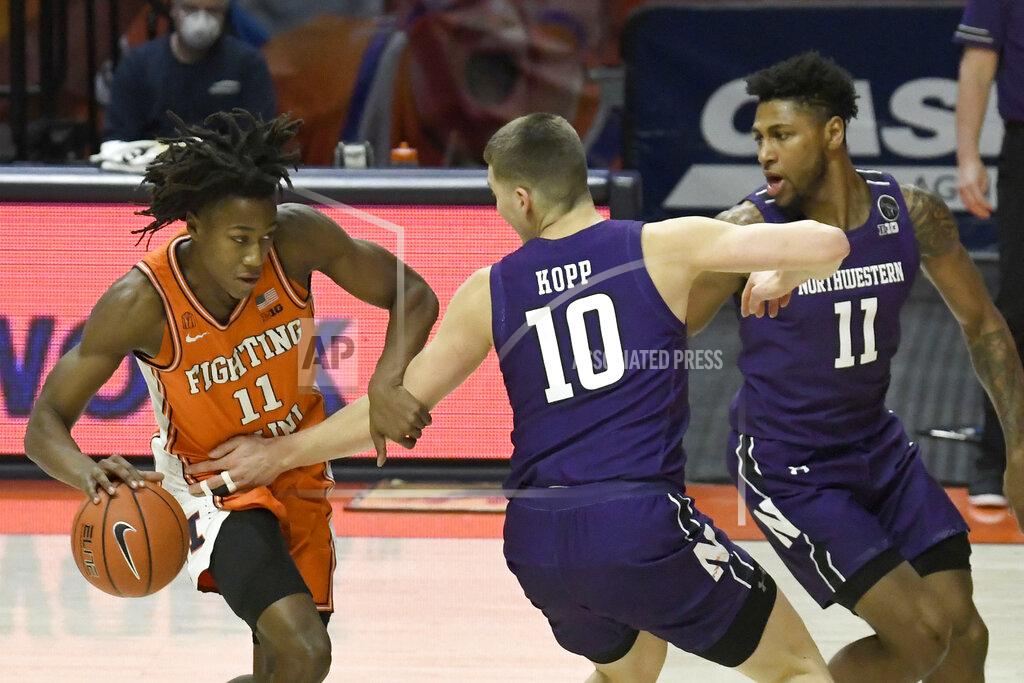 Holly Hart Illinois guard Ayo Dosunmu (11) powers past Northwestern's forward Miller Kopp (10) and guard Anthony Gaines (11) in the first half of an NCAA college basketball game Tuesday, Feb. 16, 2021, in Champaign, Ill. (AP Photo/Holly Hart)