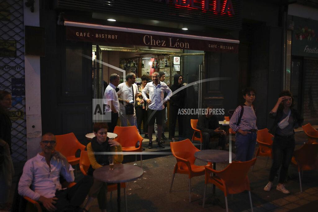 Daniel Cole Clients who enjoyed their first drinks in a cafe after he lockdown watch police advancing during a demonstration Tuesday, June 2, 2020 in Marseille, southern France. Thousands of people defied a police ban and converged on the main Paris courthouse for a demonstration to show solidarity with U.S. protesters and denounce the death of a black man in French police custody. (AP Photo/Daniel Cole)