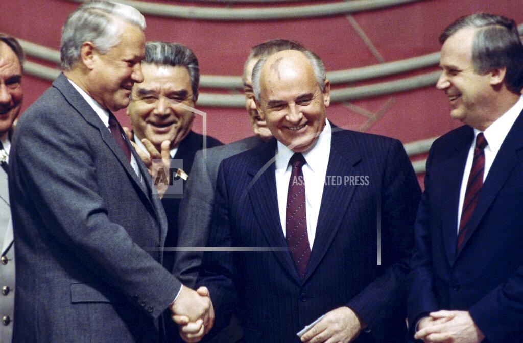 Alexander Zemlianichenko FILE - In this Thursday, Nov. 8, 1990 file photo, in a spontaneous and rare moment of accord between the Soviet Union's most popular politicians, rivals Boris Yeltsin, left, and Mikhail Gorbachev shake hands at a Kremlin ceremony on the 73rd anniversary of the Bolshevik Revolution in Moscow. Former Soviet leader Mikhail Gorbachev turned 90 on Tuesday March 2, 2021,, receiving greetings from the Kremlin and global leaders while Russians remained divided over his legacy. (AP Photo/Alexander Zemlianichenko, File)