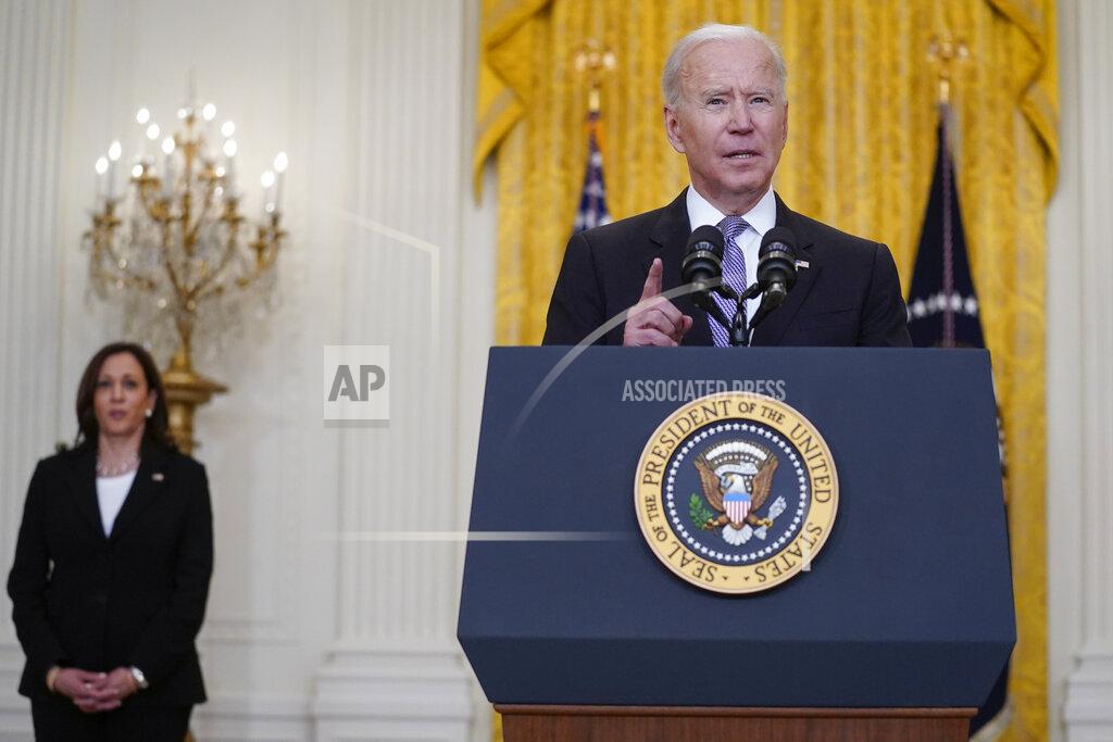 Vice President Kamala Harris listens as President Joe Biden speaks about distribution of COVID-19 vaccines, in the East Room of the White House, Monday, May 17, 2021, in Washington. (AP Photo/Evan Vucci)