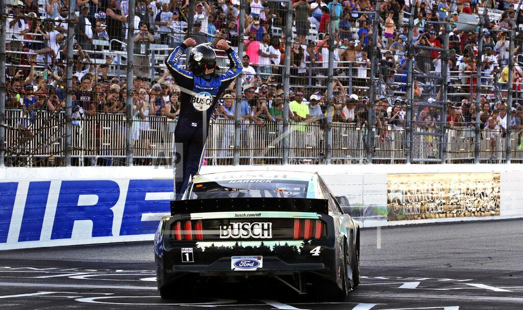 Charles Krupa Kevin Harvick raises his arms toward fans after winning a NASCAR Cup Series auto race at New Hampshire Motor Speedway in Loudon, N.H., Sunday, July 21, 2019. (AP Photo/Charles Krupa)