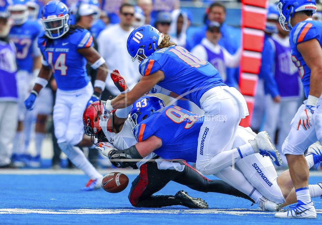 Steve Conner Boise State defensive tackle Chase Hatada (93) knocks the ball loose from San Diego State wide receiver BJ Busbee, left, in the first half of an NCAA college football game, Saturday, Oct. 6, 2018, in Boise, Idaho. Boise State recovered the fumble. (AP Photo/Steve Conner)