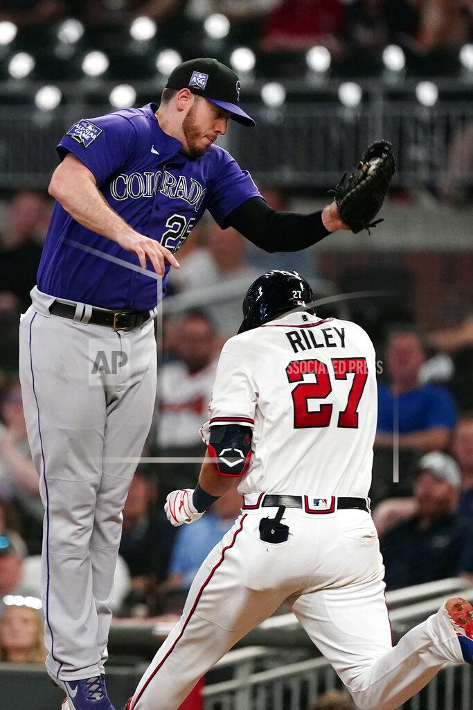 John Bazemore Atlanta Braves' Austin Riley (27) is safe at first base as Colorado Rockies first baseman C.J. Cron (25) handles the wild throw from shortstop Trevor Story in the sixth inning of a baseball game Tuesday, Sept. 14, 2021, in Atlanta. (AP Photo/John Bazemore)