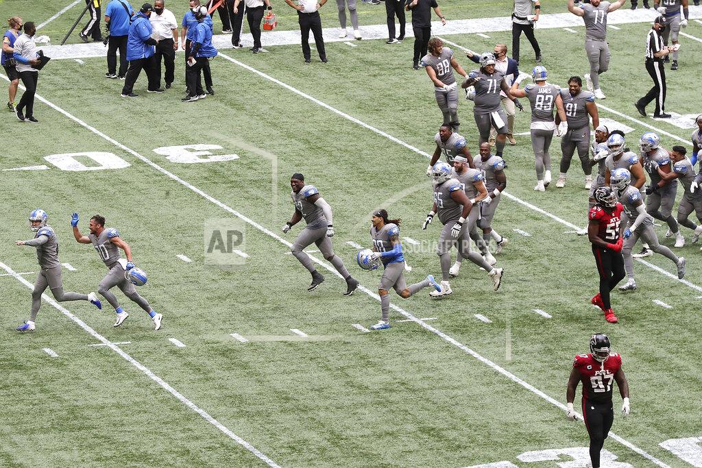 Curtis Compton Detroit Lions kicker Matt Prater, far left, is chased off the field by celebrating teammates after making the extra point attempt to defeat the Atlanta Falcons as time expired in an NFL football game while Falcons players Grady Jarrett, bottom right, and Steven Means walk off the field Sunday, Oct. 25, 2020, in Atlanta. (Curtis Compton/Atlanta Journal-Constitution via AP)