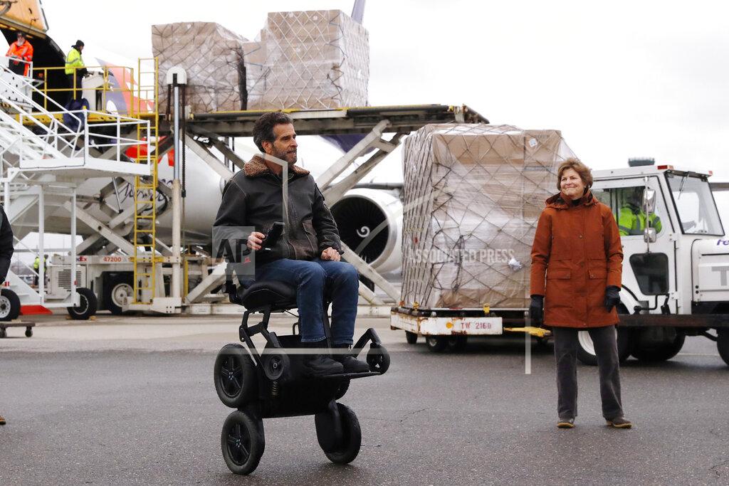 Charles Krupa U.S. Sen. Jeanne Shaheen (D-NH), right, looks toward inventor Dean Kamen as over 110,000 pounds of personal protective equipment (PPE) from Shanghai, China, delivered to protect medical workers and first responders fighting the COVID-19 virus outbreak, is unloaded from a cargo plane at Manchester-Boston Regional Airport in Manchester, New Hampshire, Thursday, April 30, 2020. (AP Photo/Charles Krupa)