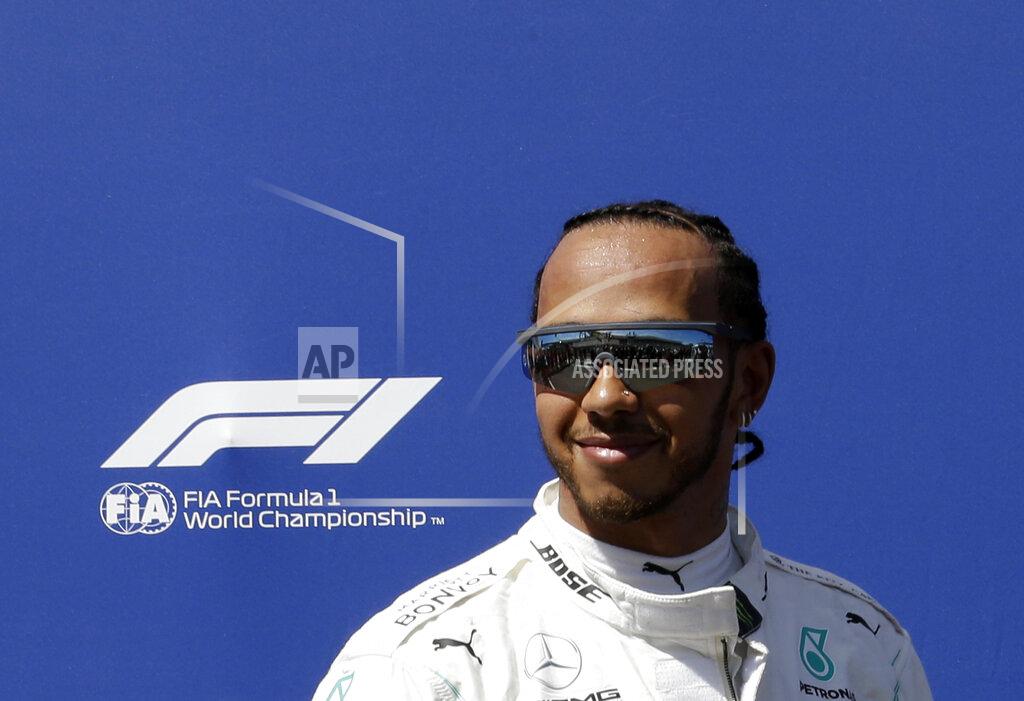 Claude Paris Mercedes driver Lewis Hamilton of Britain smiles after he clocked the fastest time during the qualifying session at the Paul Ricard racetrack in Le Castellet, southern France, Saturday, June 22, 2019. The French Formula One Grand Prix will be held on Sunday. (AP Photo/Claude Paris)