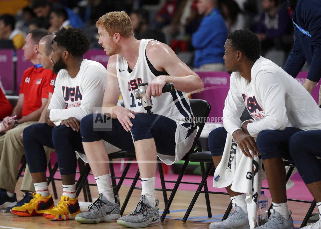Fernando Llano United States' Geoffrey Groselle, center, massages his leg as he sits on the bench during a basketball first round game against the Virgin Islands at the Pan American Games in Lima, Peru, Wednesday, July 31, 2019. (AP Photo/Fernando Llano)
