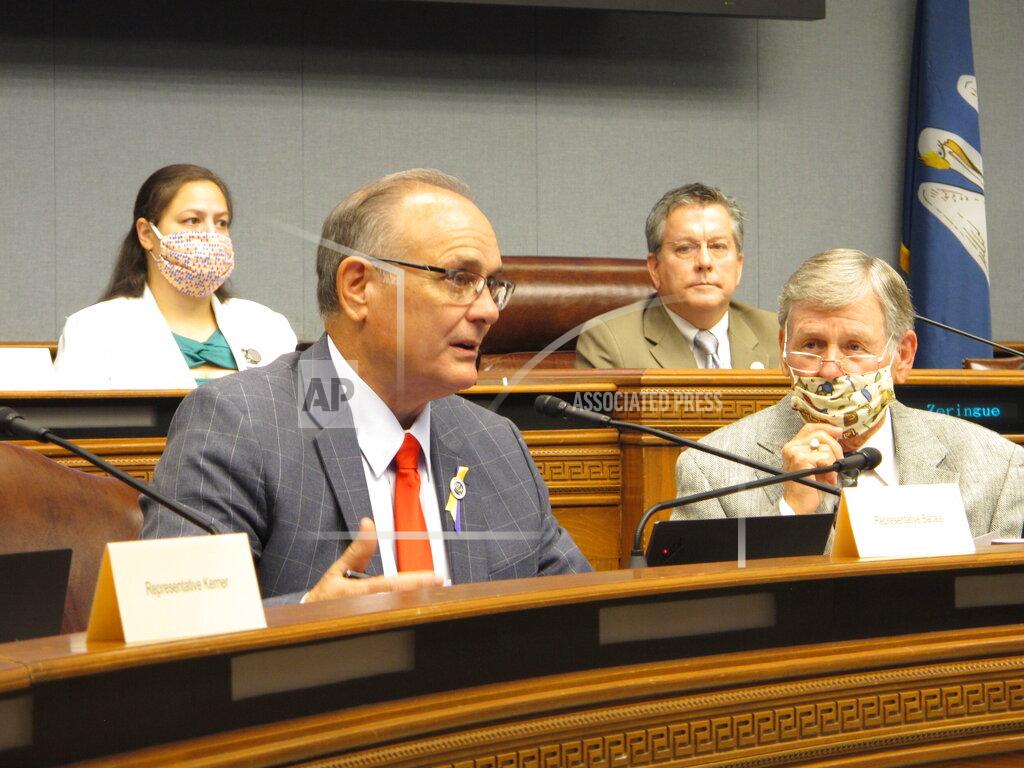 Rep. Tony Bacala, R-Prairieville, left, asks questions about the budget while Rep. Francis Thompson, D-Delhi, listens on Thursday, May 21, 2020, in Baton Rouge, La. The House Appropriations Committee advanced a package of bills to close a $1 billion state budget gap, largely in line with plans recommended by Gov. John Bel Edwards. (AP Photo/Melinda Deslatte)