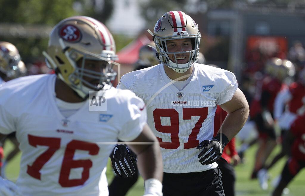 Jeff Chiu San Francisco 49ers' Nick Bosa (97) warms up behind Jordan Thompson (76) at the team's NFL football training camp in Santa Clara, Calif., Saturday, July 27, 2019. (AP Photo/Jeff Chiu)