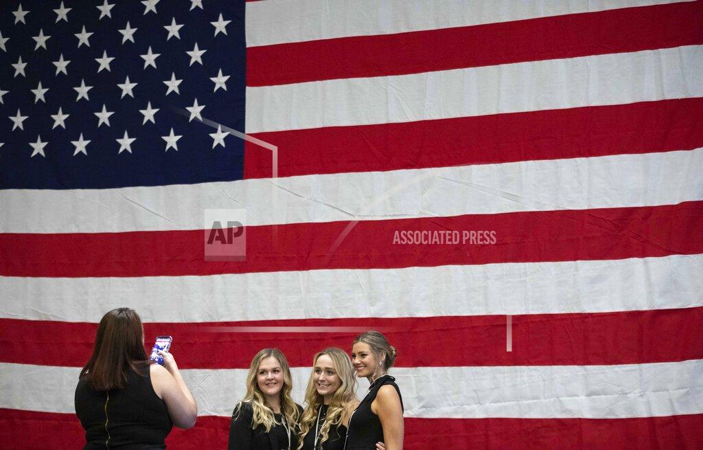 Branden Camp Supporters of Sen. Kelly Loeffler, R-Ga., pose for a photo during a watch party at the Grand Hyatt Hotel on Election Night, Tuesday, Nov. 3, 2020, in Atlanta. (Branden Camp/Atlanta Journal-Constitution via AP)