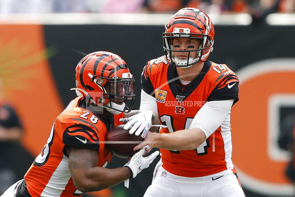 Gary Landers Cincinnati Bengals quarterback Andy Dalton (14) hands the ball to running back Joe Mixon (28) in the first half of an NFL football game against the Arizona Cardinals, Sunday, Oct. 6, 2019, in Cincinnati. (AP Photo/Gary Landers)