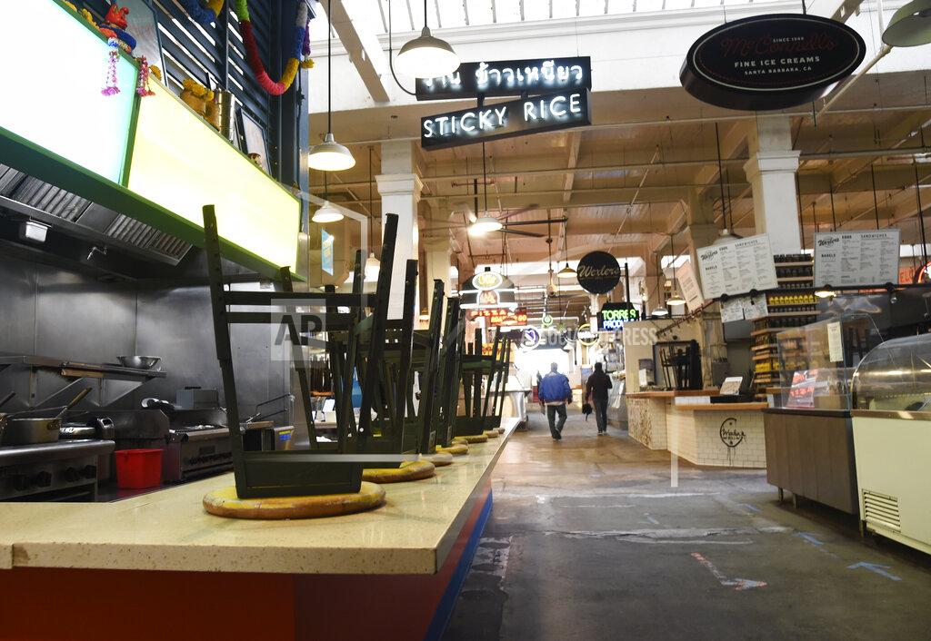 Chris Pizzello Customer stools are stored on a bar in the nearly empty Grand Central Market food emporium, which remains open for takeout orders only, as stay-at-home orders continue in California due to the coronavirus outbreak, Friday, April 10, 2020, in Los Angeles. (AP Photo/Chris Pizzello)