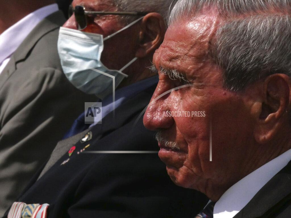 Nicolas Garriga Charles Shay, right, the 96-year-old native American from Indian Island, Maine,attends a D-Day ceremony in Carentan, Normandy, Friday, June 4, 2021. In a small Normandy town where paratroopers landed in the early hours of D-Day, applauds broke the silence to honor Charles Shay. He was the only veteran to attend the ceremony in Carentan commemorating the 77th anniversary of the assault that led to the end World War II. Shay was a 19-year-old U.S. Army medic when he landed on Omaha Beach. (AP Photo/Nicolas Garriga)