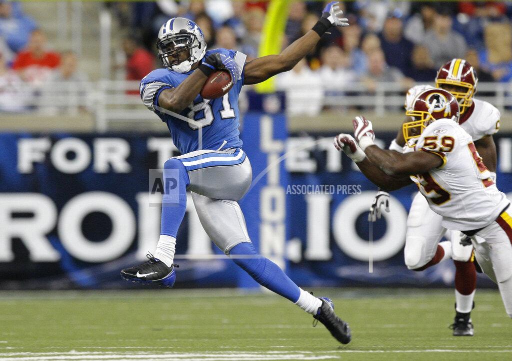Paul Sancya FILE - In this Oct. 26, 2008, file photo, Detroit Lions wide receiver Calvin Johnson makes catch against the Washington Redskins in the fourth quarter of an NFL football game in Detroit. Calvin Johnson is simply in awe that he will soon join Jim Brown and Gale Sayers as Pro Football Hall of Famers inducted at the age of 35 years old or younger. (AP Photo/Paul Sancya, File)